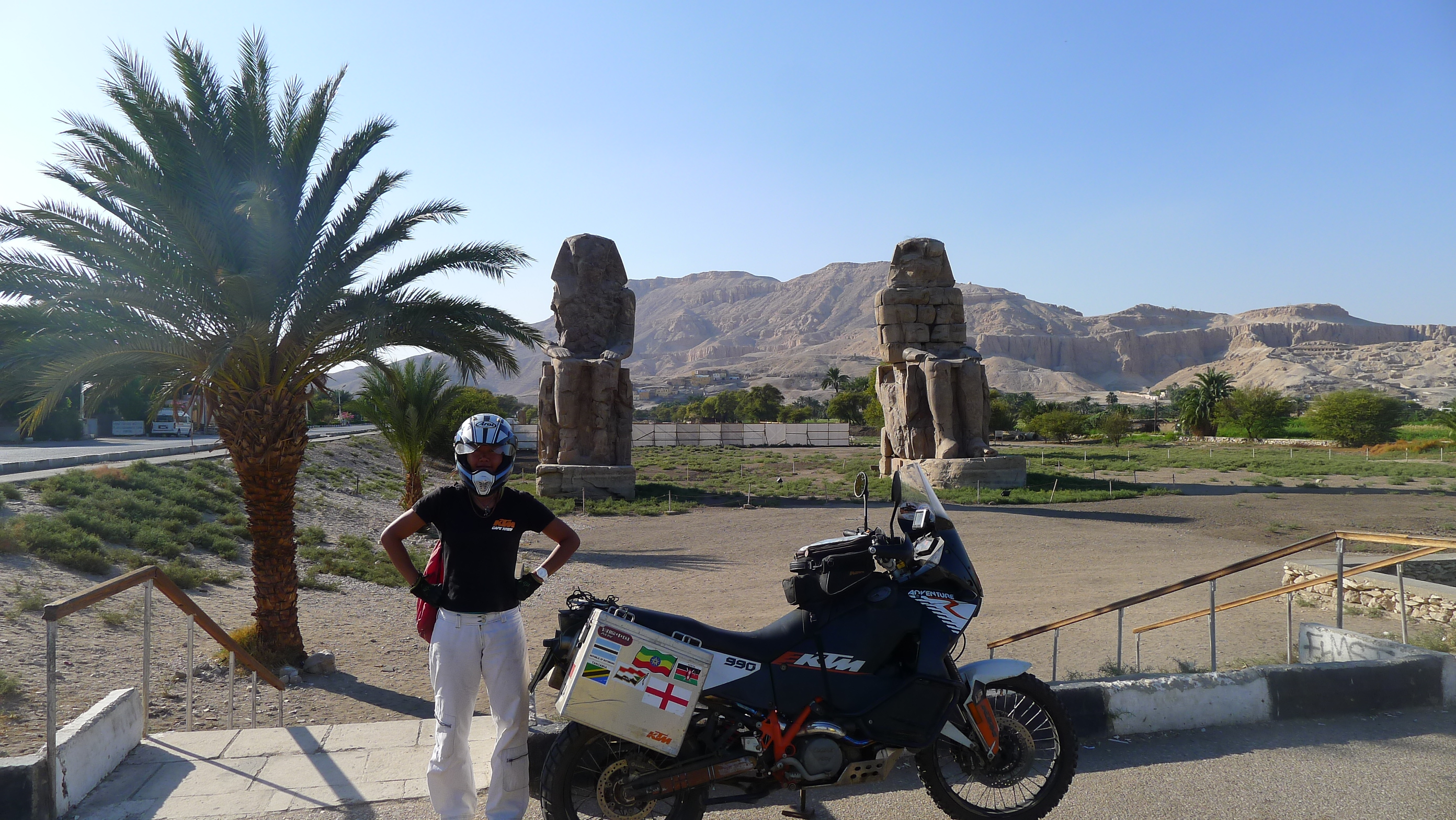 Posing against the ancient statues in Luxor near the valley of the Kings.