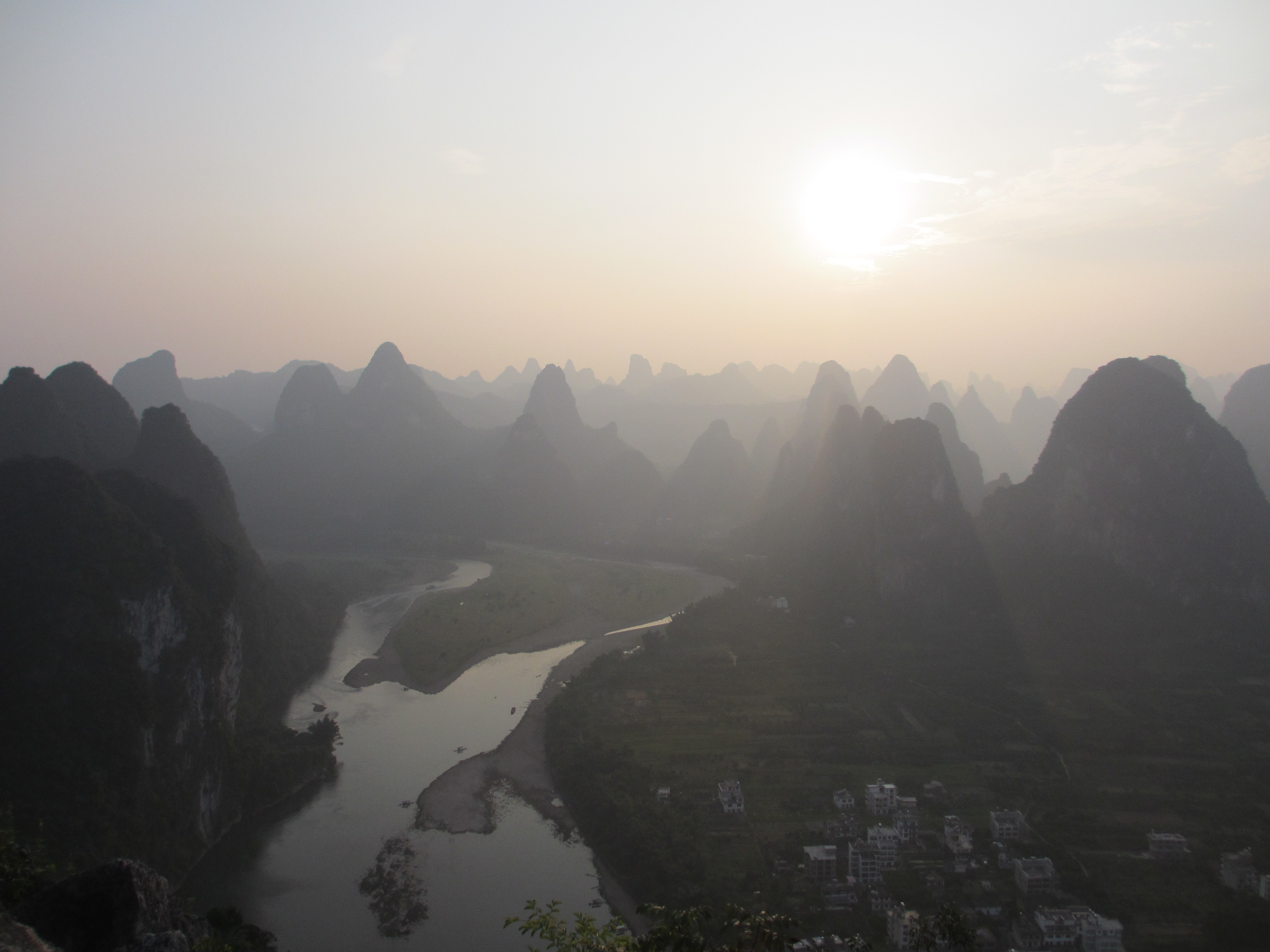 I climbed to top of one of the Karst hills (220 meters) in Xing Ping to take picture of surrounding hills along Li Jiang river towards Yang Shuo. 